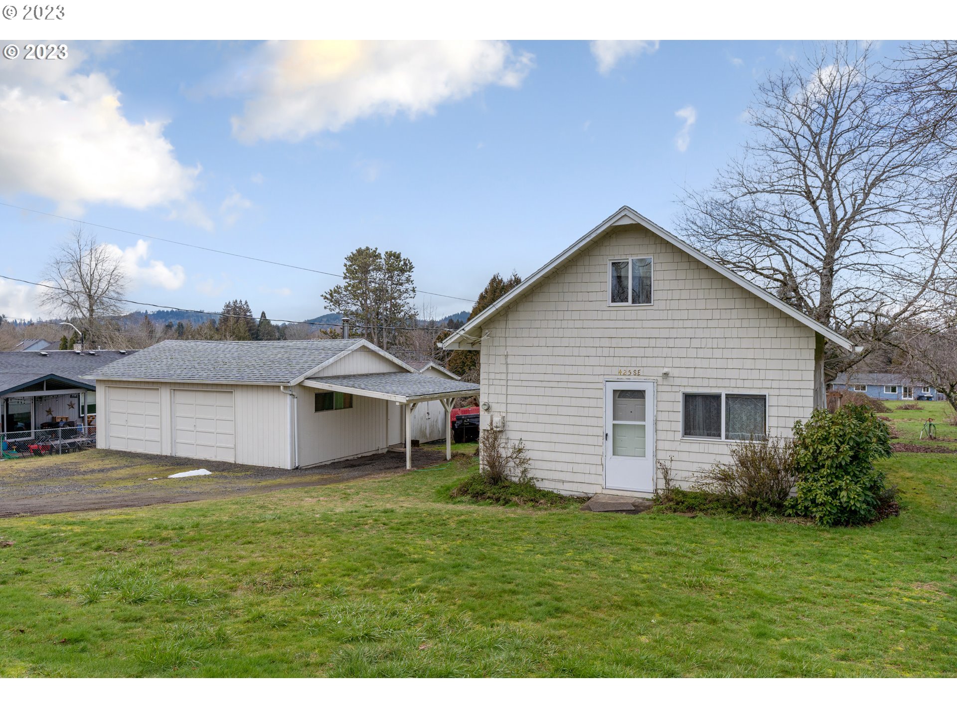 a front view of house with yard and green space