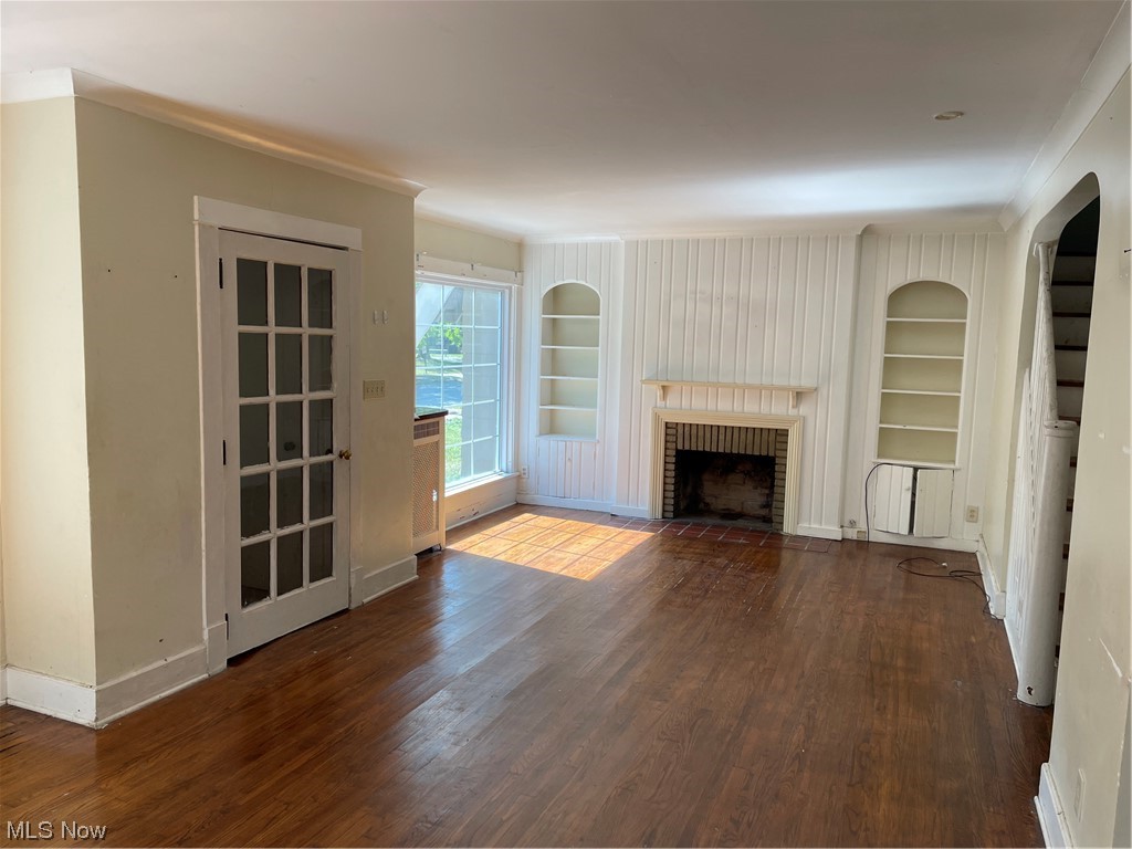 1730 Wood Road Cleveland Heights, OH 44121 - Photo 5 of 34 Hardwood floored living room with built in shelves and a fireplace