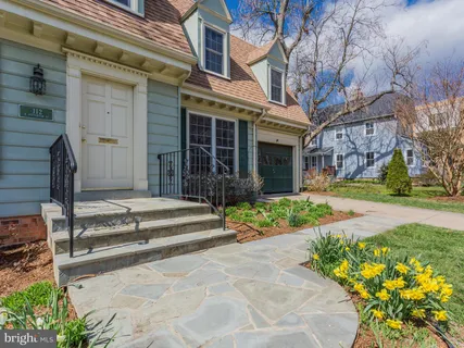 a front view of a house with a garden and porch