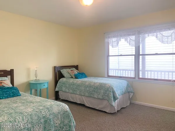 a bedroom with bed and window