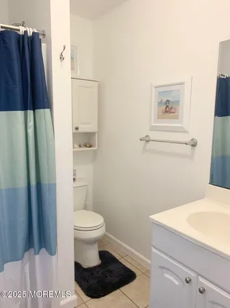 a bathroom with a toilet and a shower curtain