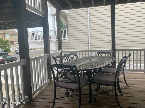 a view of a chairs and table on the deck