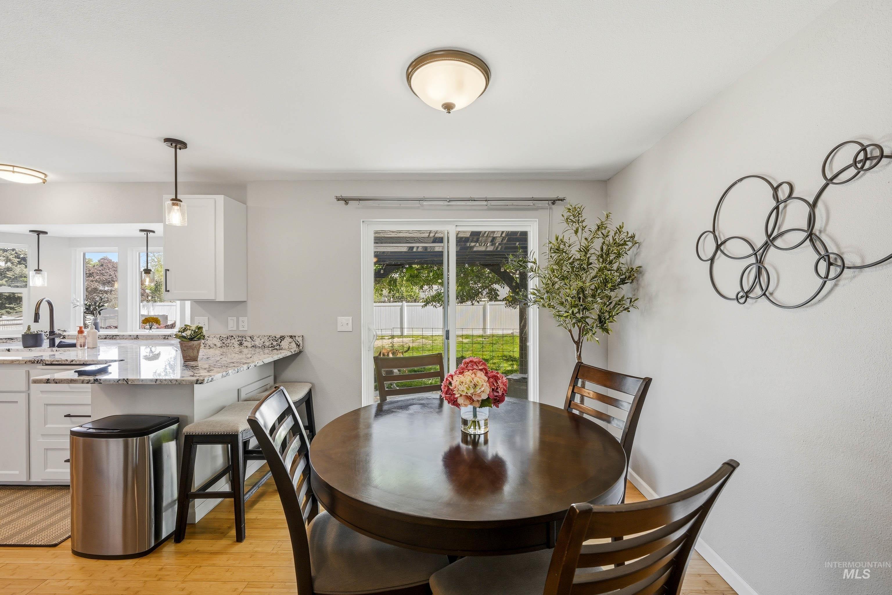 3715 18th Street Lewiston, ID 83501 - Photo 14 of 30 Dining area with wood-finish flooring and a sliding glass door providing access to the exterior