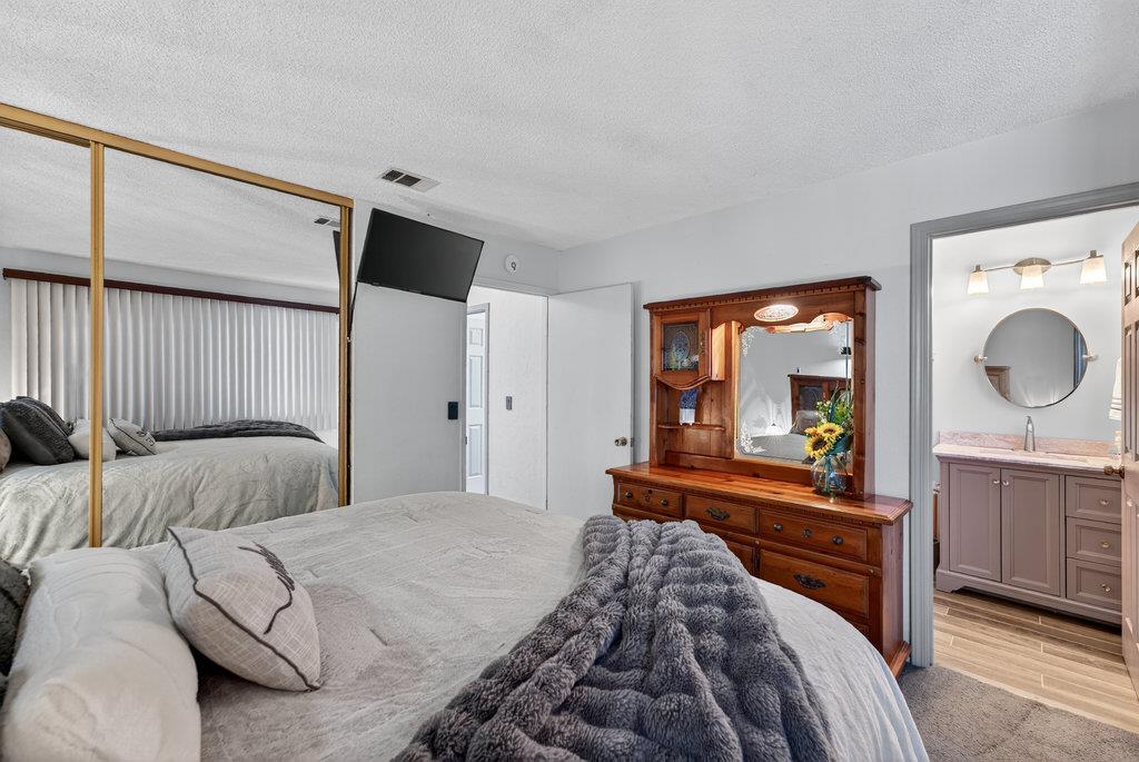 12932 Truman Street Salinas, CA 93906 - Photo 12 of 24 a bedroom with a large bed and a large window