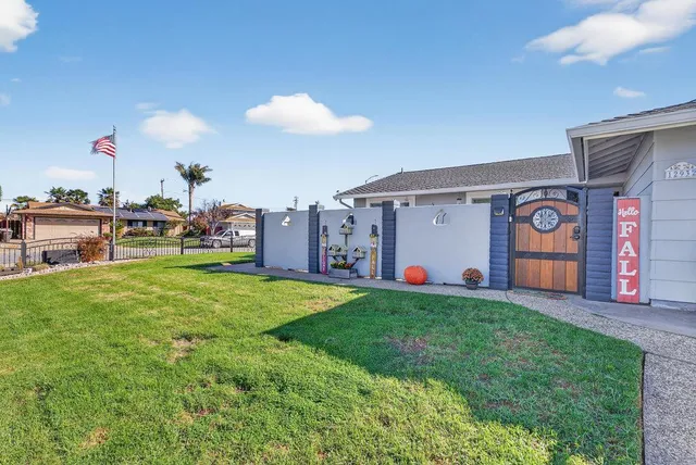 a view of a backyard with a garden and entertaining space