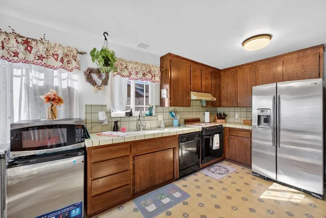 a kitchen with a sink stove and refrigerator