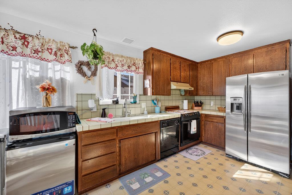 12932 Truman Street Salinas, CA 93906 - Photo 8 of 24 a kitchen with a sink stove and refrigerator