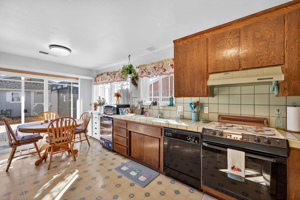 12932 Truman Street Salinas, CA 93906 - Photo 9 of 24 a kitchen with stainless steel appliances granite countertop a stove top oven a sink dishwasher and cabinets