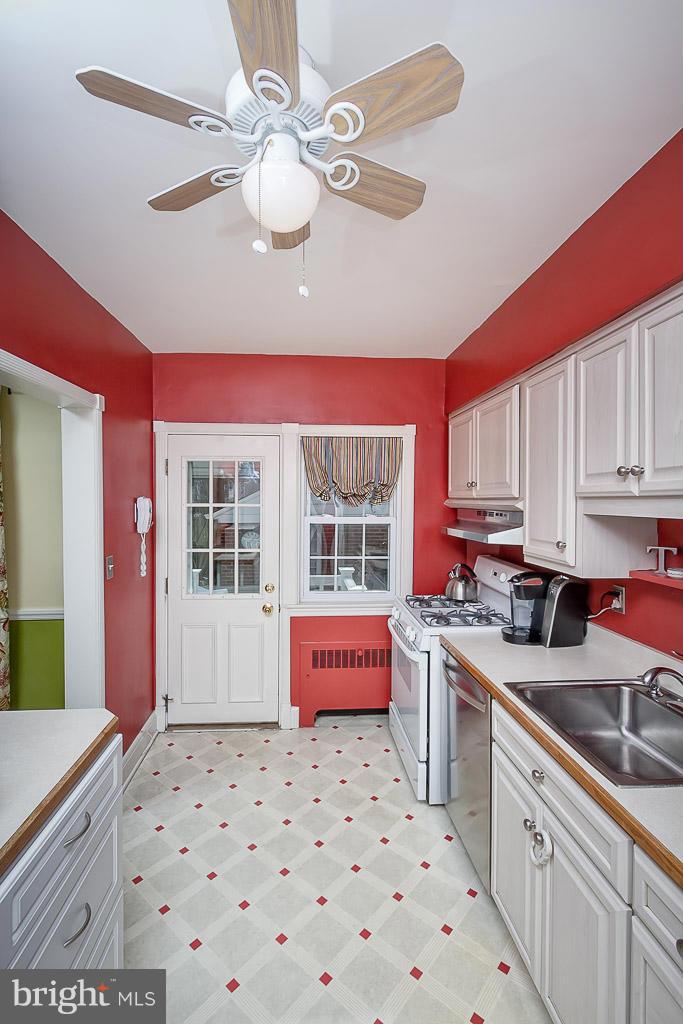 227 Dumbarton Road Baltimore, MD 21212 - Photo 13 of 30 a kitchen with a sink stove top oven and cabinets