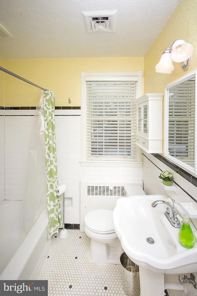227 Dumbarton Road Baltimore, MD 21212 - Photo 21 of 30 a bathroom with a sink a toilet a tub and shower