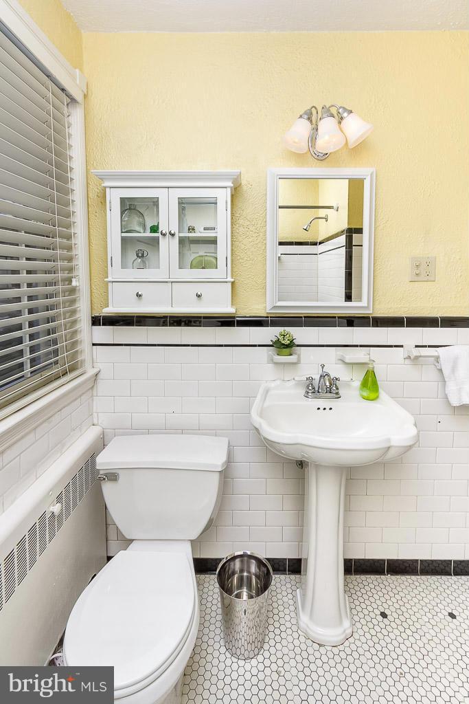 227 Dumbarton Road Baltimore, MD 21212 - Photo 22 of 30 a bathroom with a sink a toilet and mirror