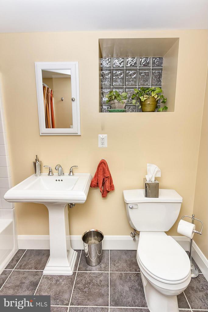 227 Dumbarton Road Baltimore, MD 21212 - Photo 24 of 30 a bathroom with a toilet sink and mirror
