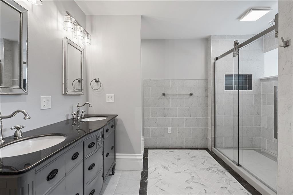 2217 Sarah Street Pittsburgh, PA 15203 - Photo 22 of 33 a bathroom with a sink double vanity and shower