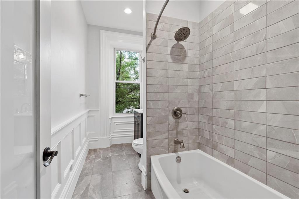 2217 Sarah Street Pittsburgh, PA 15203 - Photo 27 of 33 a bathroom with a tub and a shower