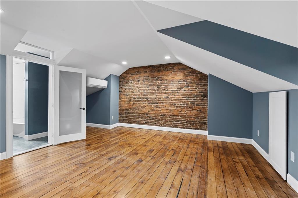 2217 Sarah Street Pittsburgh, PA 15203 - Photo 29 of 33 a view of an empty room with wooden floor and a window
