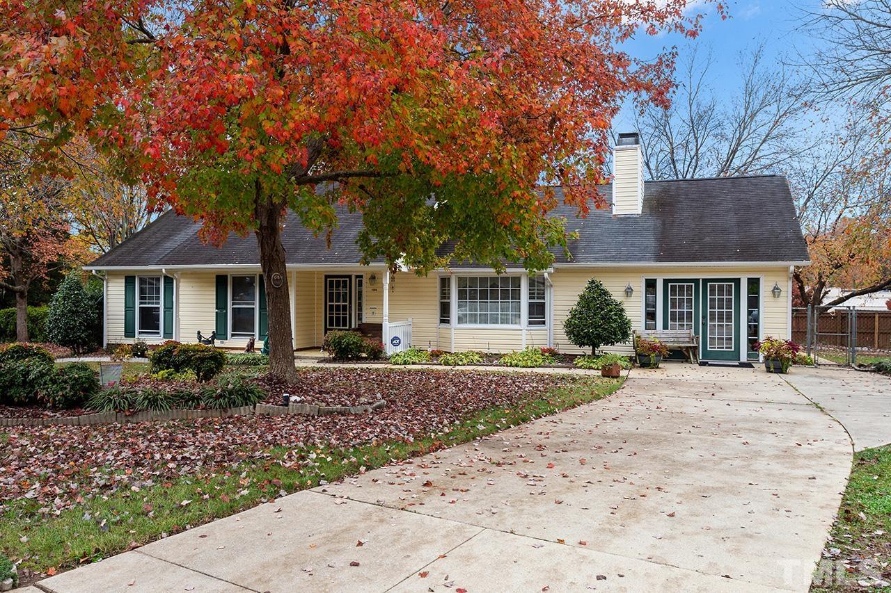 1406 Buckhorn Road Garner, NC 27529 - Photo 1 of 29 a front view of a house with a garden and trees