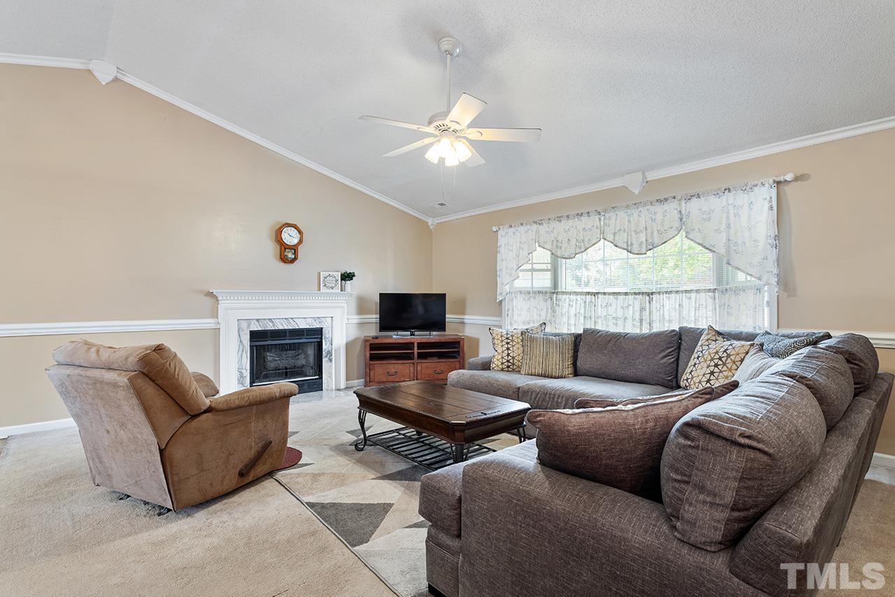 1406 Buckhorn Road Garner, NC 27529 - Photo 14 of 29 a living room with furniture and a fireplace
