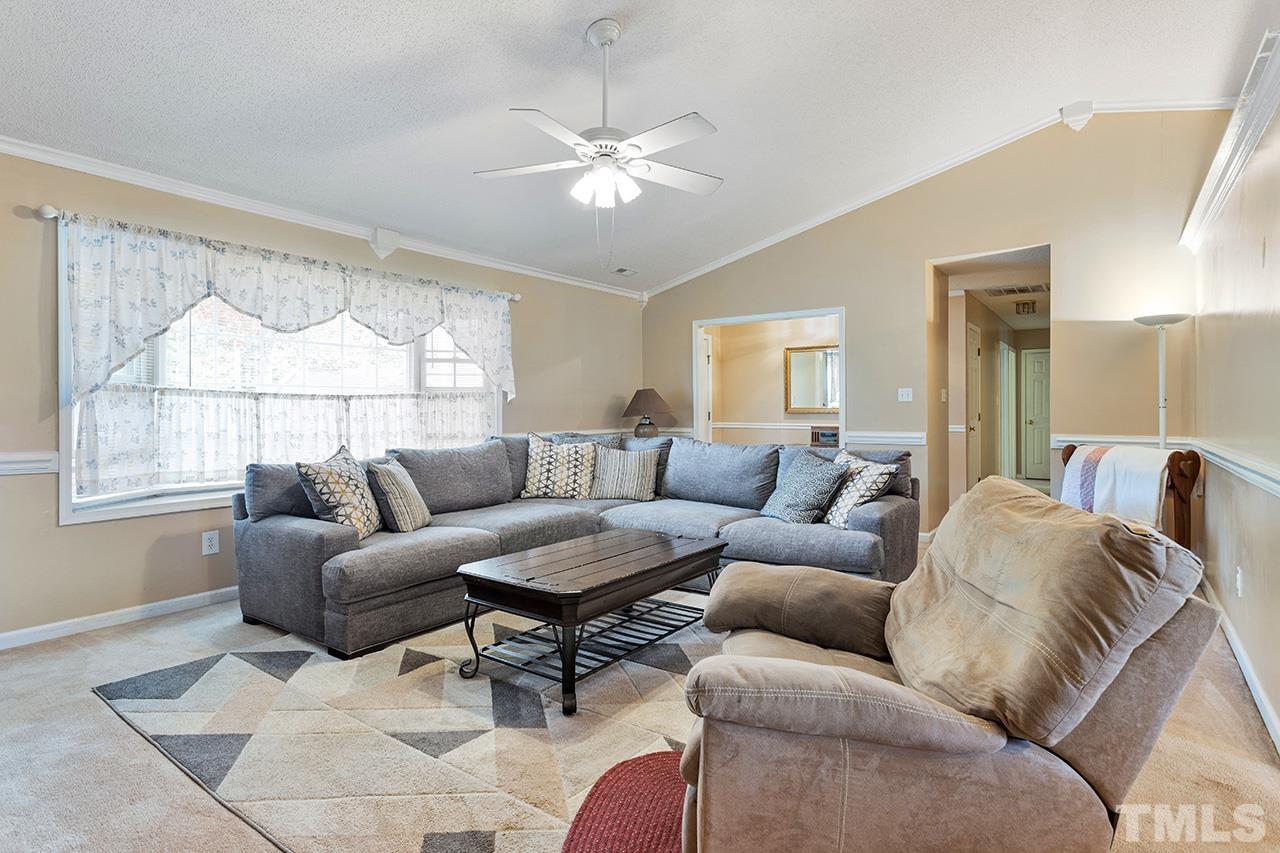 1406 Buckhorn Road Garner, NC 27529 - Photo 15 of 29 a living room with furniture and a large window