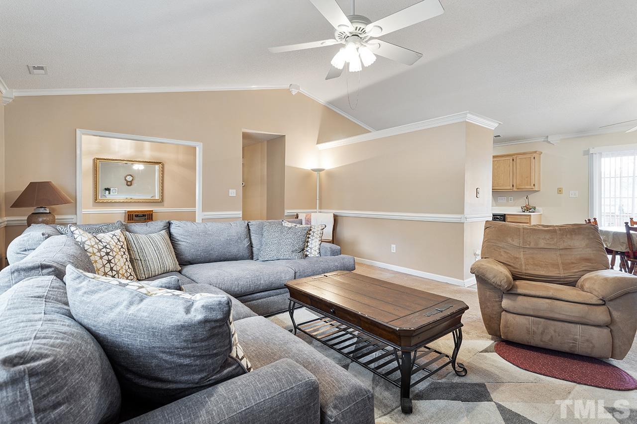 1406 Buckhorn Road Garner, NC 27529 - Photo 16 of 29 a living room with furniture a ceiling fan and a rug