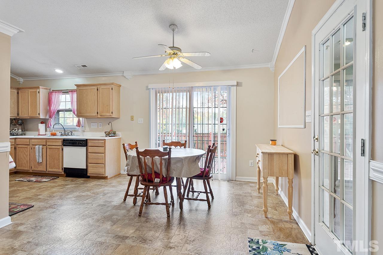 1406 Buckhorn Road Garner, NC 27529 - Photo 17 of 29 a kitchen with a table chairs sink and cabinets