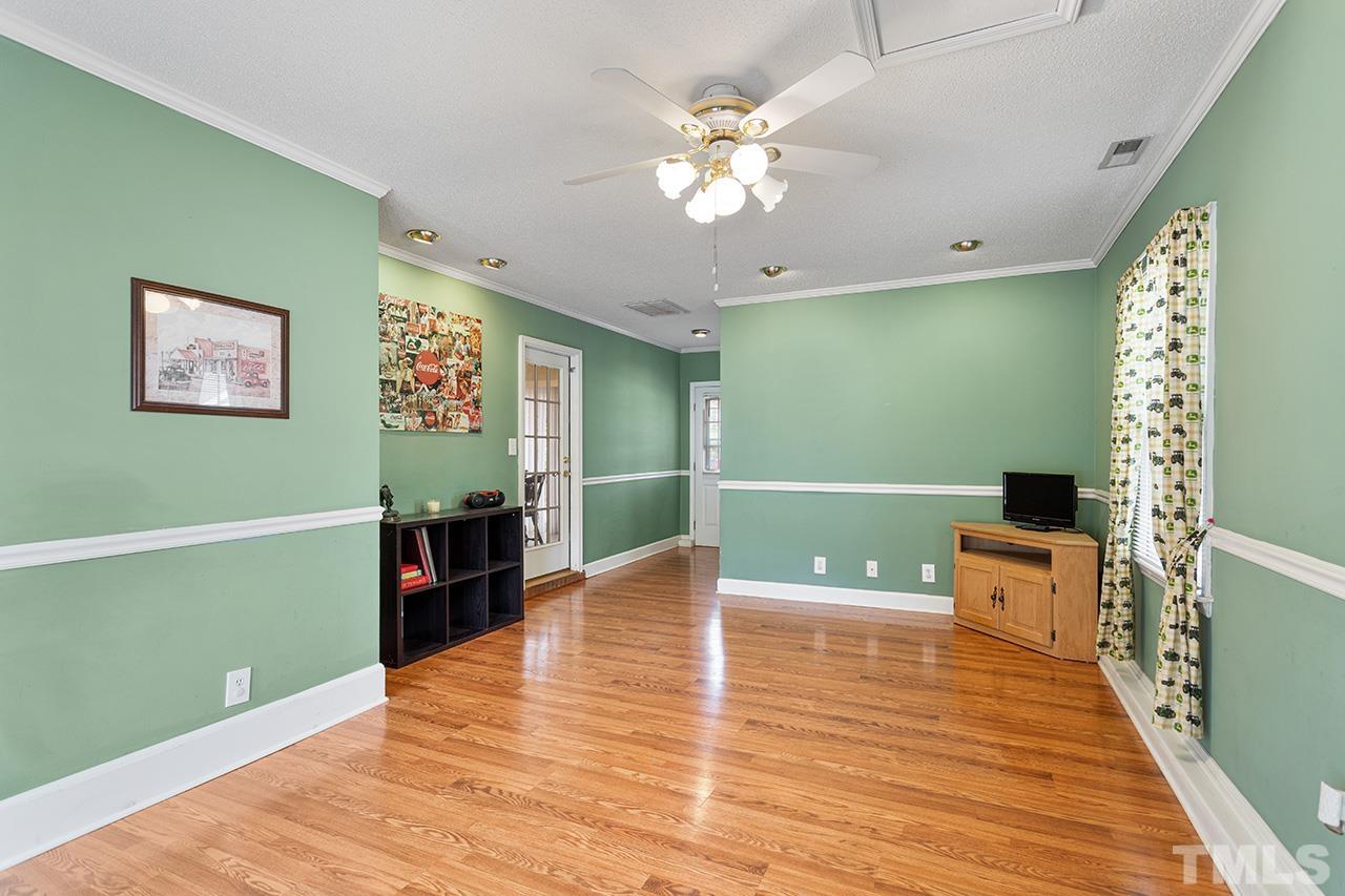 1406 Buckhorn Road Garner, NC 27529 - Photo 23 of 29 a view of an empty room with a window and wooden floor