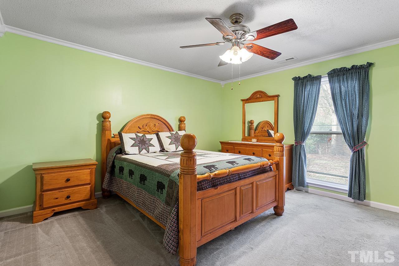 1406 Buckhorn Road Garner, NC 27529 - Photo 24 of 29 a bed room with a bed and a fish tank