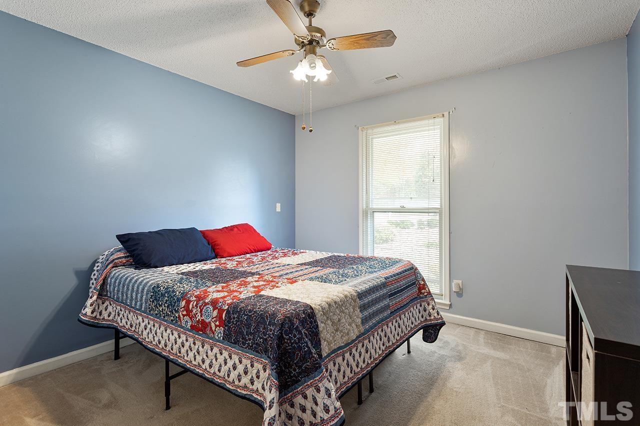 1406 Buckhorn Road Garner, NC 27529 - Photo 28 of 29 a bedroom with a bed and a window