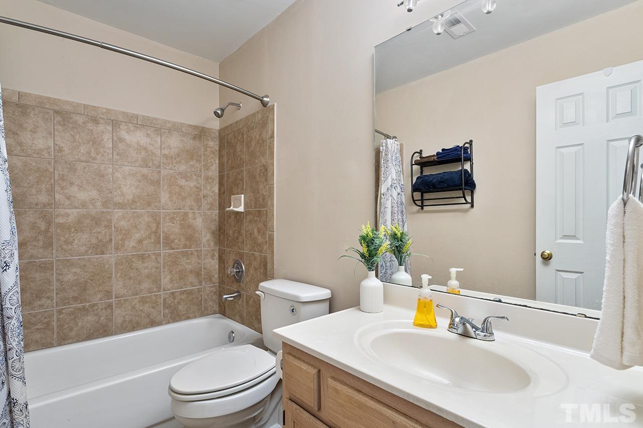 1406 Buckhorn Road Garner, NC 27529 - Photo 29 of 29 a bathroom with a sink toilet and shower