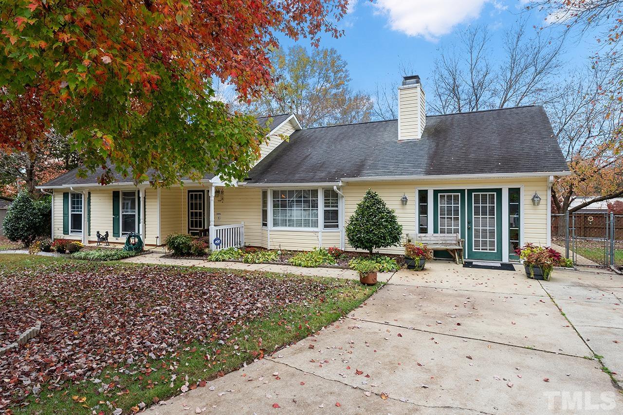 1406 Buckhorn Road Garner, NC 27529 - Photo 4 of 29 a front view of a house with a garden and patio