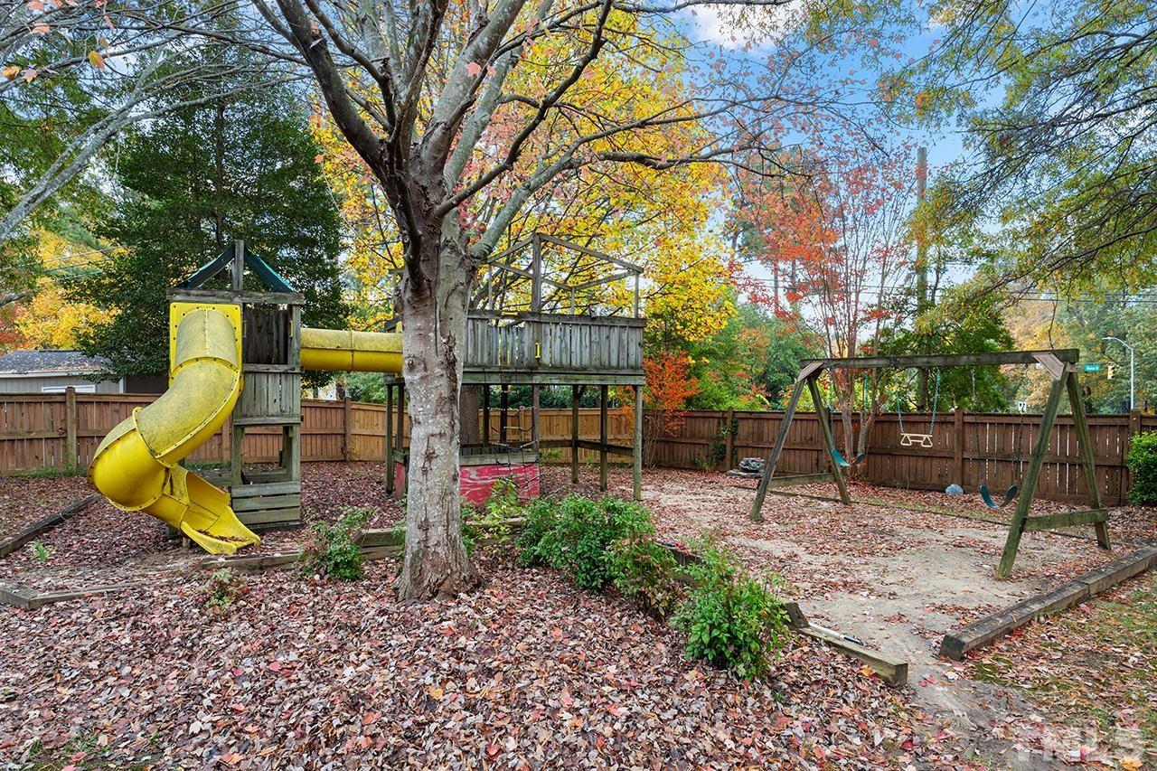 1406 Buckhorn Road Garner, NC 27529 - Photo 8 of 29 a view of a backyard with plants and tree
