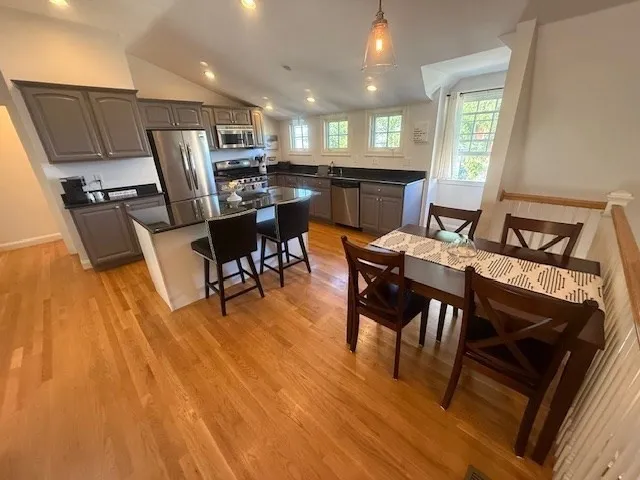 a view of a dining room with furniture window and wooden floor