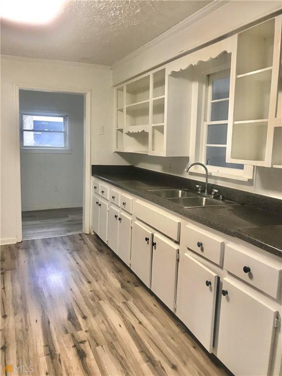 116 Edwards Street Bremen, GA 30110 - Photo 19 of 33 a kitchen with granite countertop a sink and cabinets