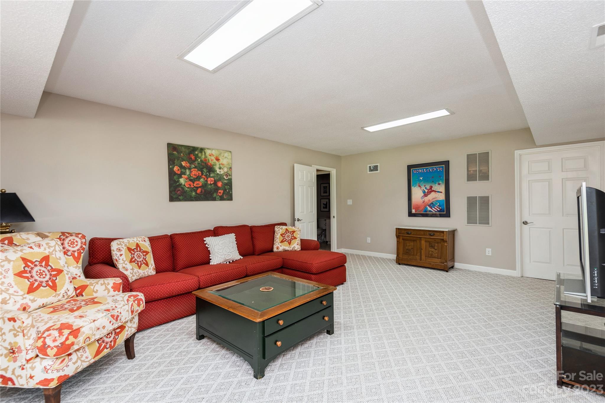 92 Fairway Ridge, Unit 8 Clover, SC 29710 - Photo 30 of 34 a living room with furniture a flat screen tv and a refrigerator