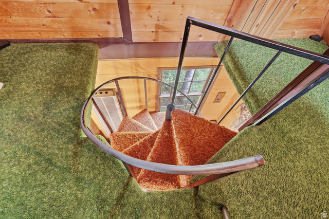 8505 South Snake Crk Road Salt Lake City, UT 84121 - Photo 24 of 67 Spiral staircase with orange shag carpeted treads, framed by a metal railing