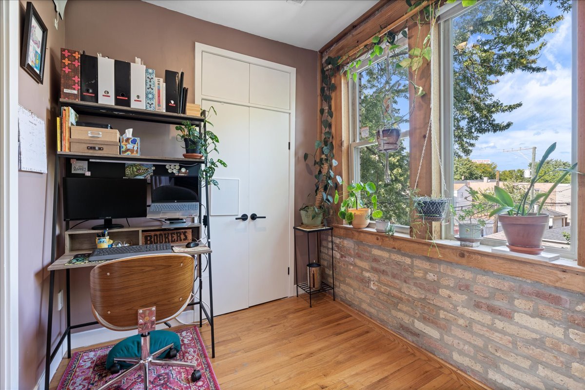 3107 West George Street, Unit 2 Chicago, IL 60618 - Photo 13 of 17 a room with furniture and a flat screen tv