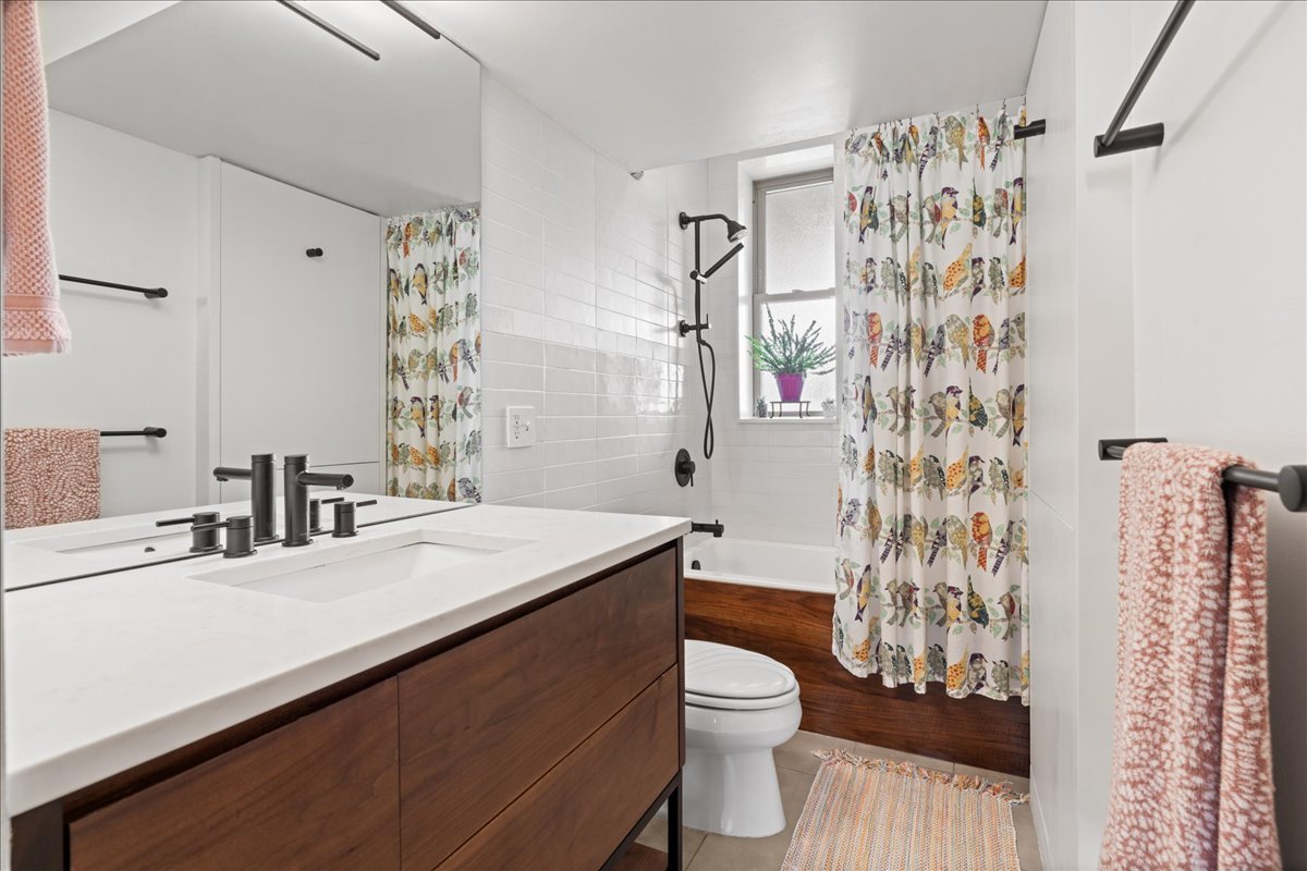 3107 West George Street, Unit 2 Chicago, IL 60618 - Photo 14 of 17 a bathroom with a sink a toilet and shower curtain