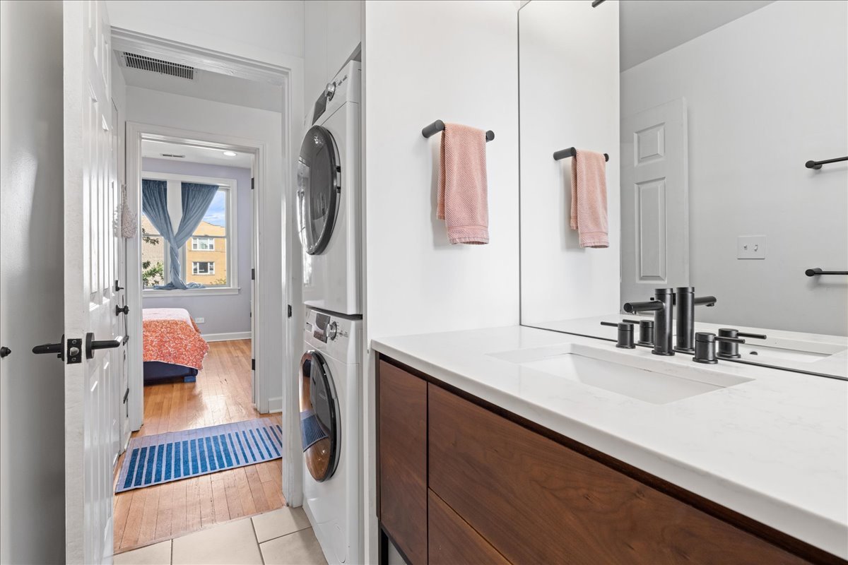 3107 West George Street, Unit 2 Chicago, IL 60618 - Photo 15 of 17 a en suite bathroom with a sink and a mirror