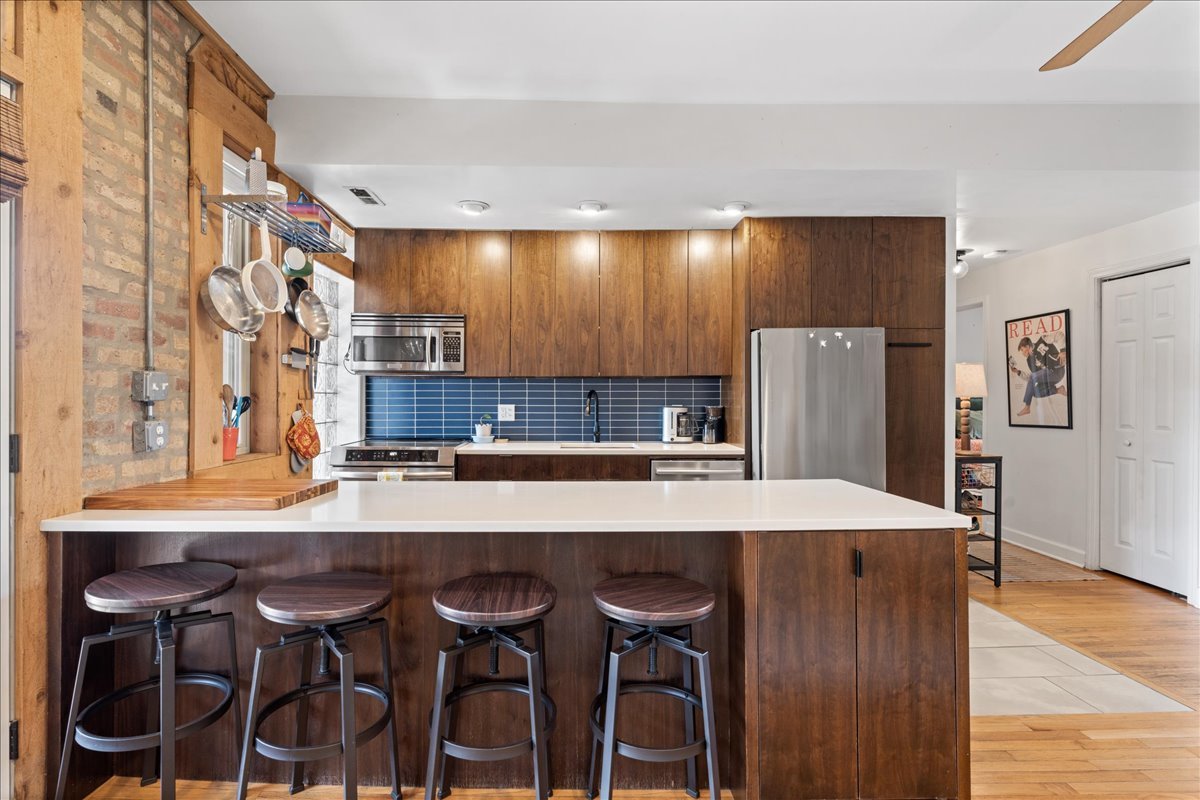 3107 West George Street, Unit 2 Chicago, IL 60618 - Photo 6 of 17 a view of a dining room with furniture and wooden floor