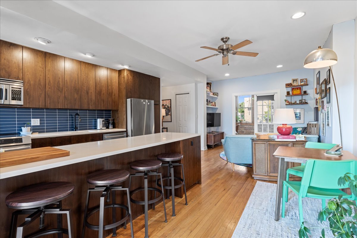 3107 West George Street, Unit 2 Chicago, IL 60618 - Photo 8 of 17 a kitchen with a dining table chairs sink and stove