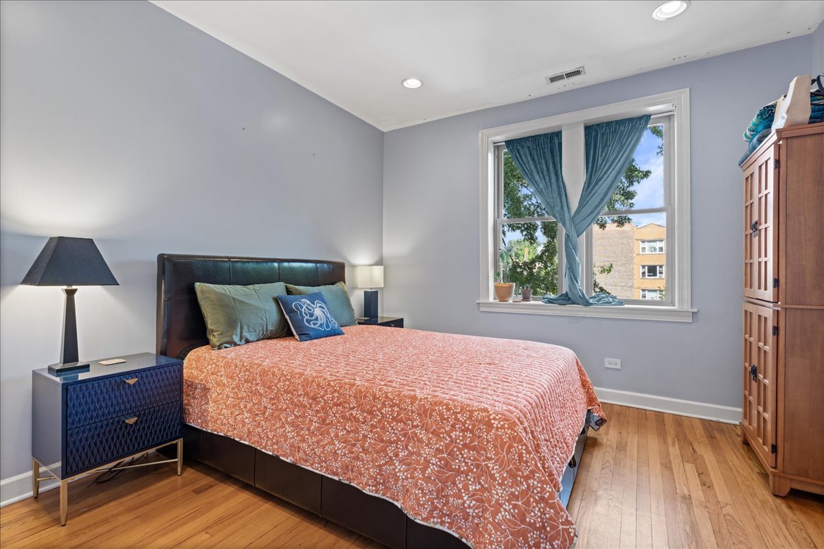 3107 West George Street, Unit 2 Chicago, IL 60618 - Photo 10 of 17 a bedroom with a bed and a window