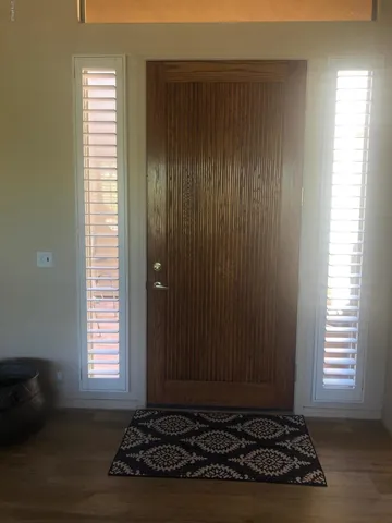 a view of a livingroom with wooden floor and a window