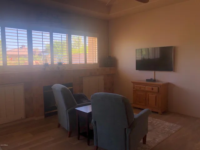 a view of a workspace with furniture and a window