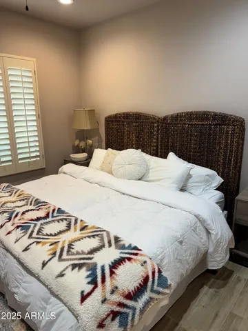 a bedroom with a bed and a night stand