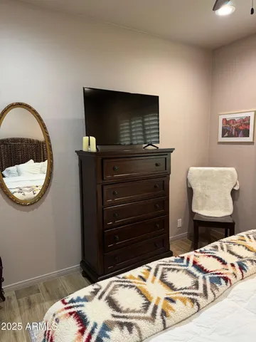 a bedroom with a bed and a television