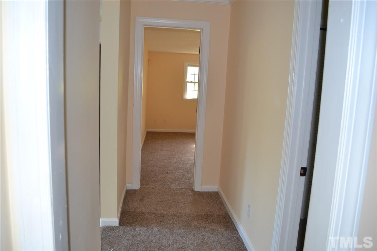 4623 Bragg Road Durham, NC 27704 - Photo 13 of 25 a view of a hallway with wooden floor