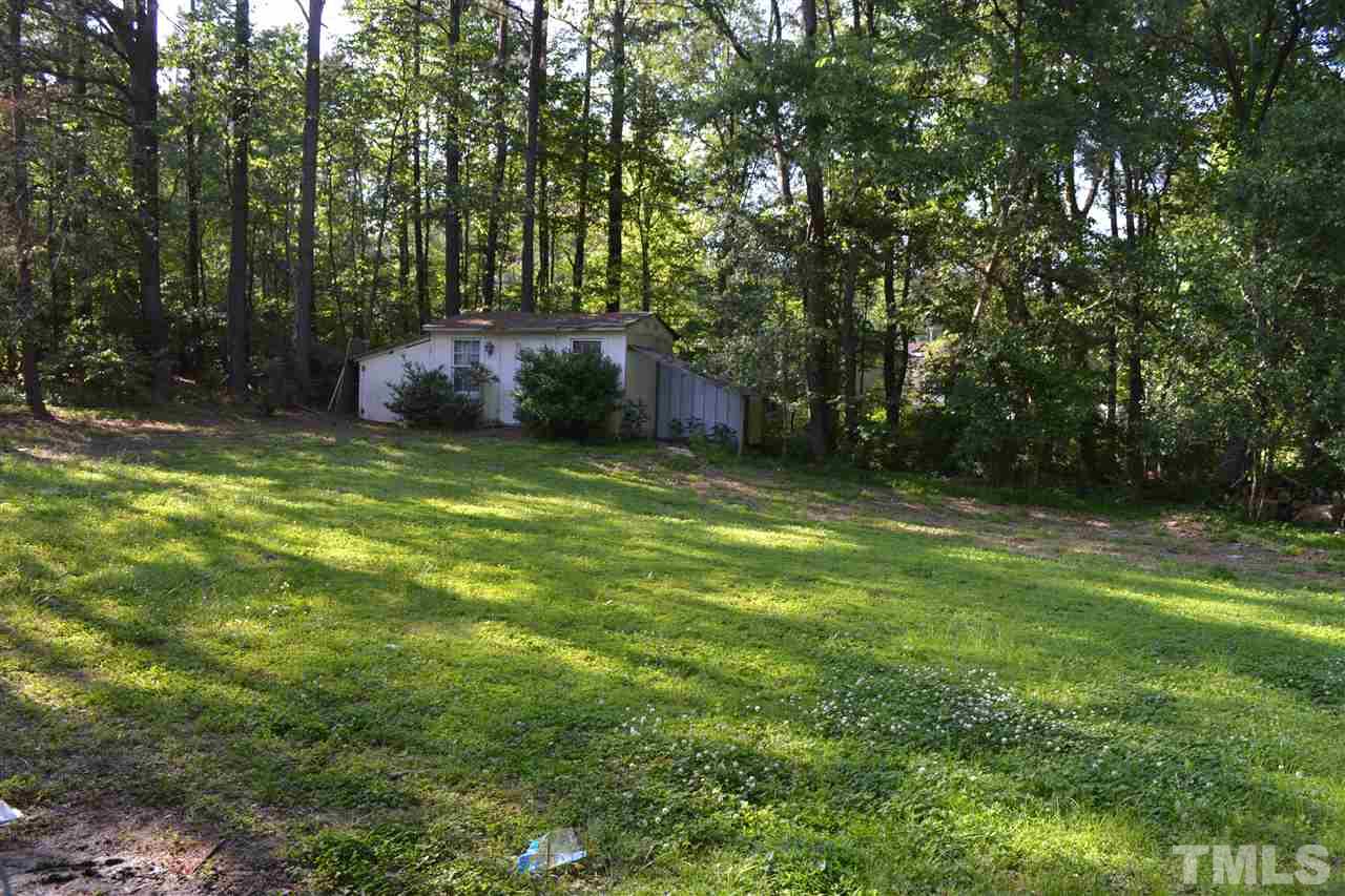 4623 Bragg Road Durham, NC 27704 - Photo 18 of 25 a backyard of a house with lots of plants and tree