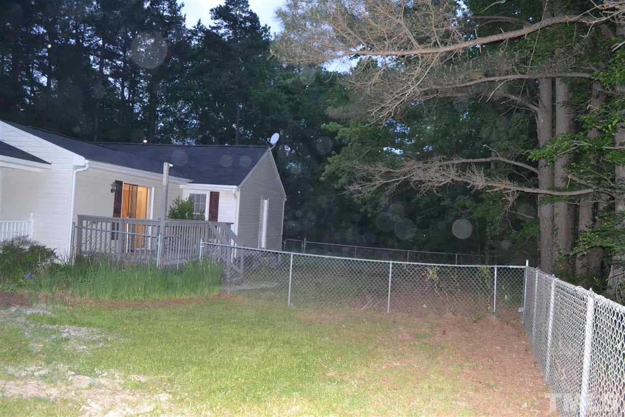 4623 Bragg Road Durham, NC 27704 - Photo 23 of 25 a backyard of a house with lots of green space