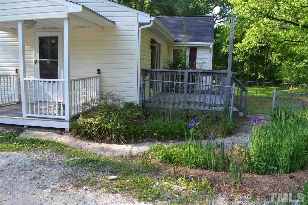 4623 Bragg Road Durham, NC 27704 - Photo 24 of 25 a view of house with a yard and potted plants