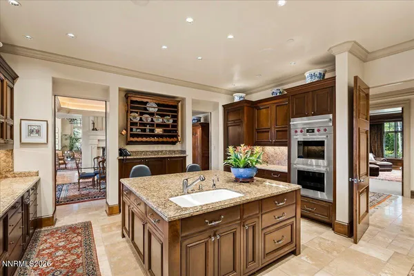 a living room with furniture a bookshelf and a large window