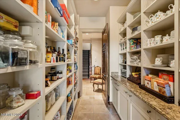 a living room with furniture and large windows